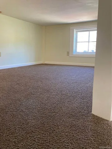 a kitchen with a stove a refrigerator and cabinets