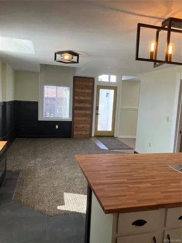 a view of an empty room with closet and mirror