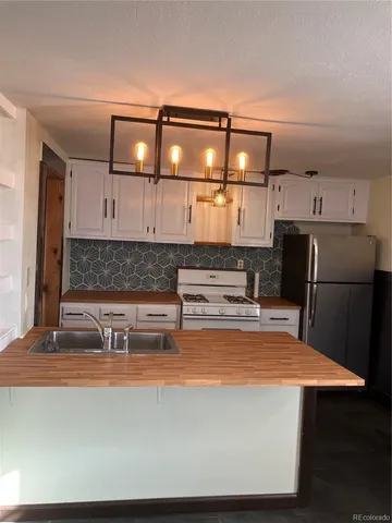 a kitchen with stainless steel appliances a refrigerator and cabinets