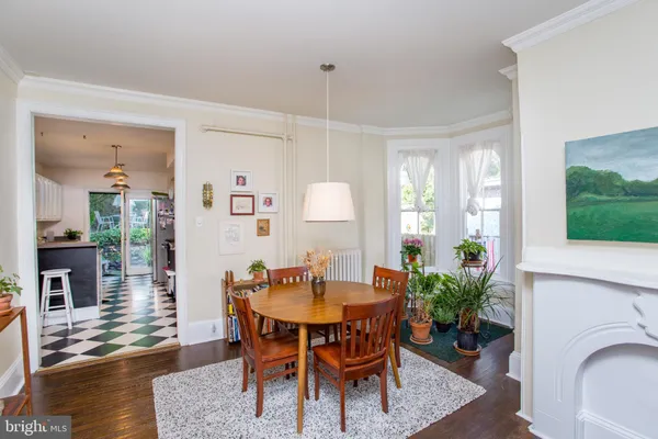 a kitchen that has a lot of cabinets appliances and a window