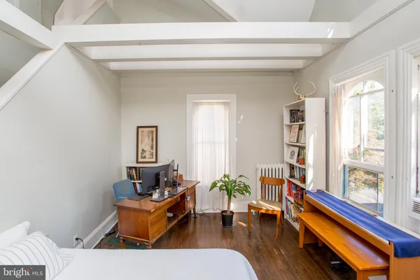 a bedroom with a bed and a book shelf