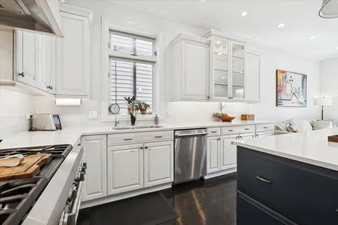 a living room with furniture and kitchen view