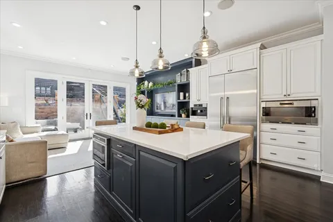 a bathroom with a granite countertop toilet a sink and a mirror
