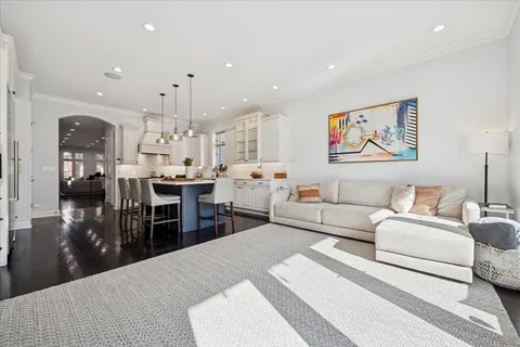 a living room with furniture a fireplace and a kitchen view