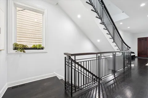 a bedroom with a bed a table and painting on the wall