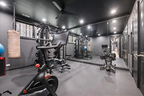 a view of a livingroom with furniture wooden floor chandelier and windows