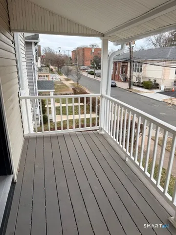 a view of a balcony with wooden floor