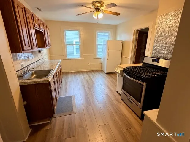 a kitchen with granite countertop a stove and a refrigerator