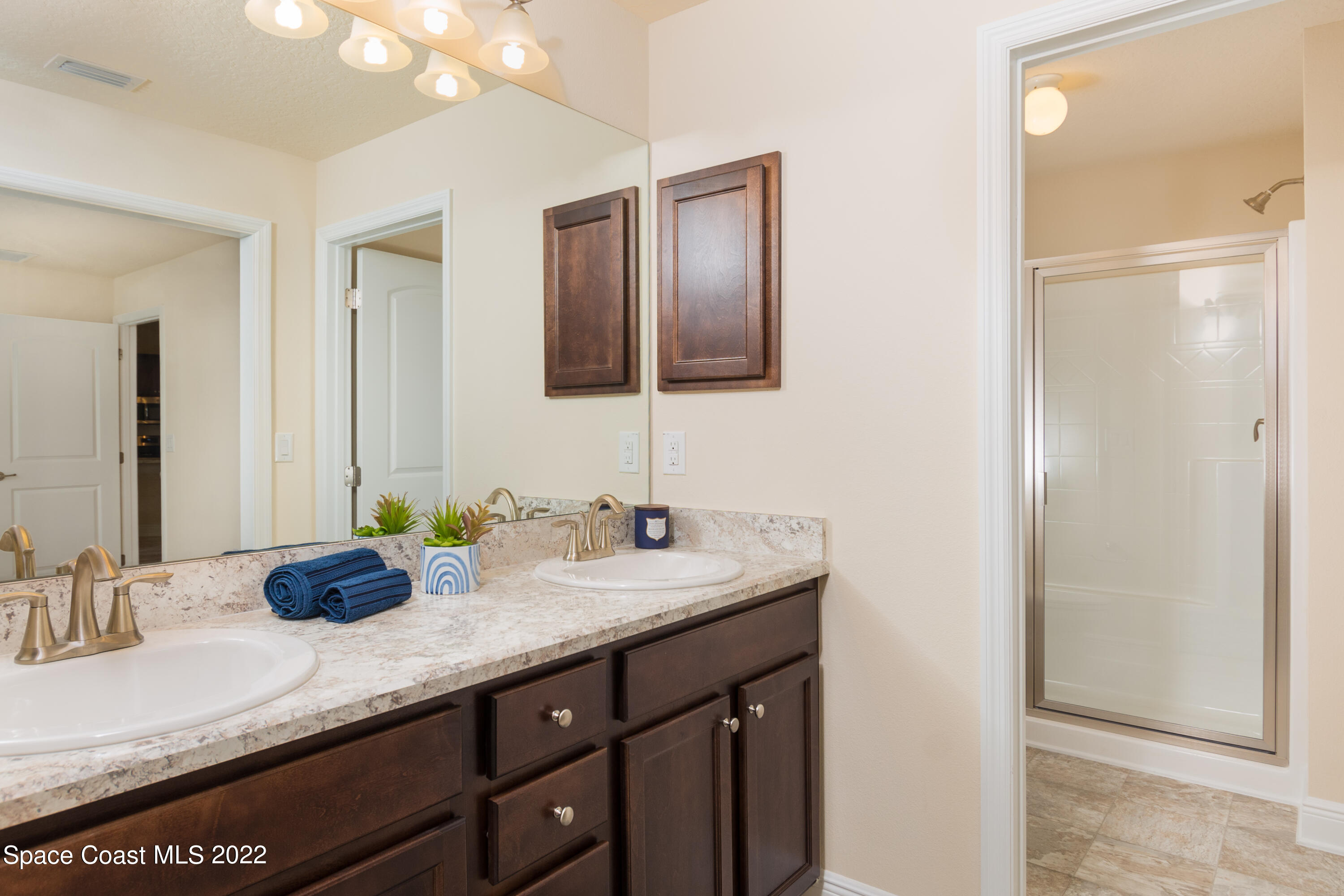1490 Saxony Road Southwest Palm Bay, FL 32908 - Photo 11 of 15 a bathroom with a granite countertop double vanity sink and a mirror
