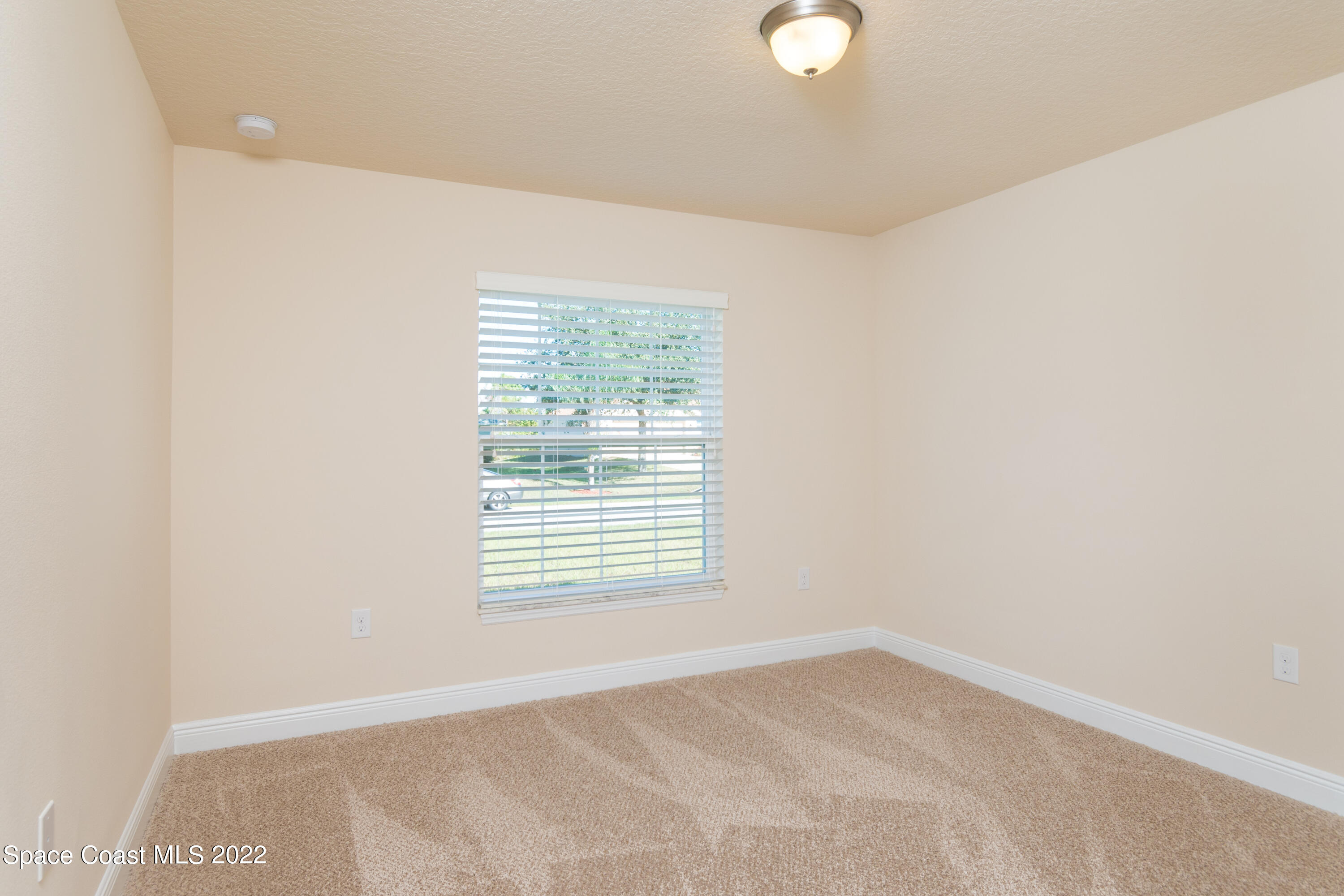 1490 Saxony Road Southwest Palm Bay, FL 32908 - Photo 12 of 15 a view of an empty room with a window