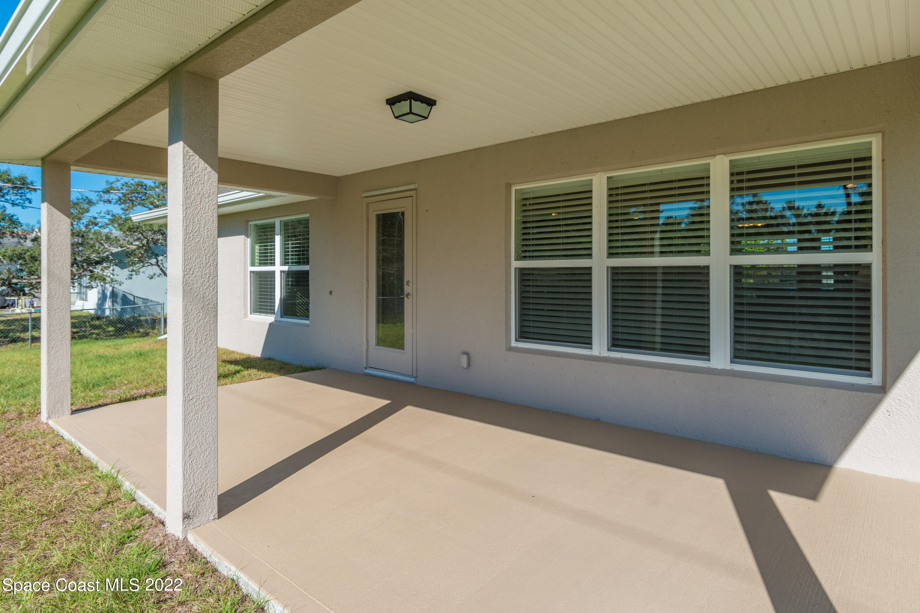 1490 Saxony Road Southwest Palm Bay, FL 32908 - Photo 14 of 15 a front view of a house with a large window