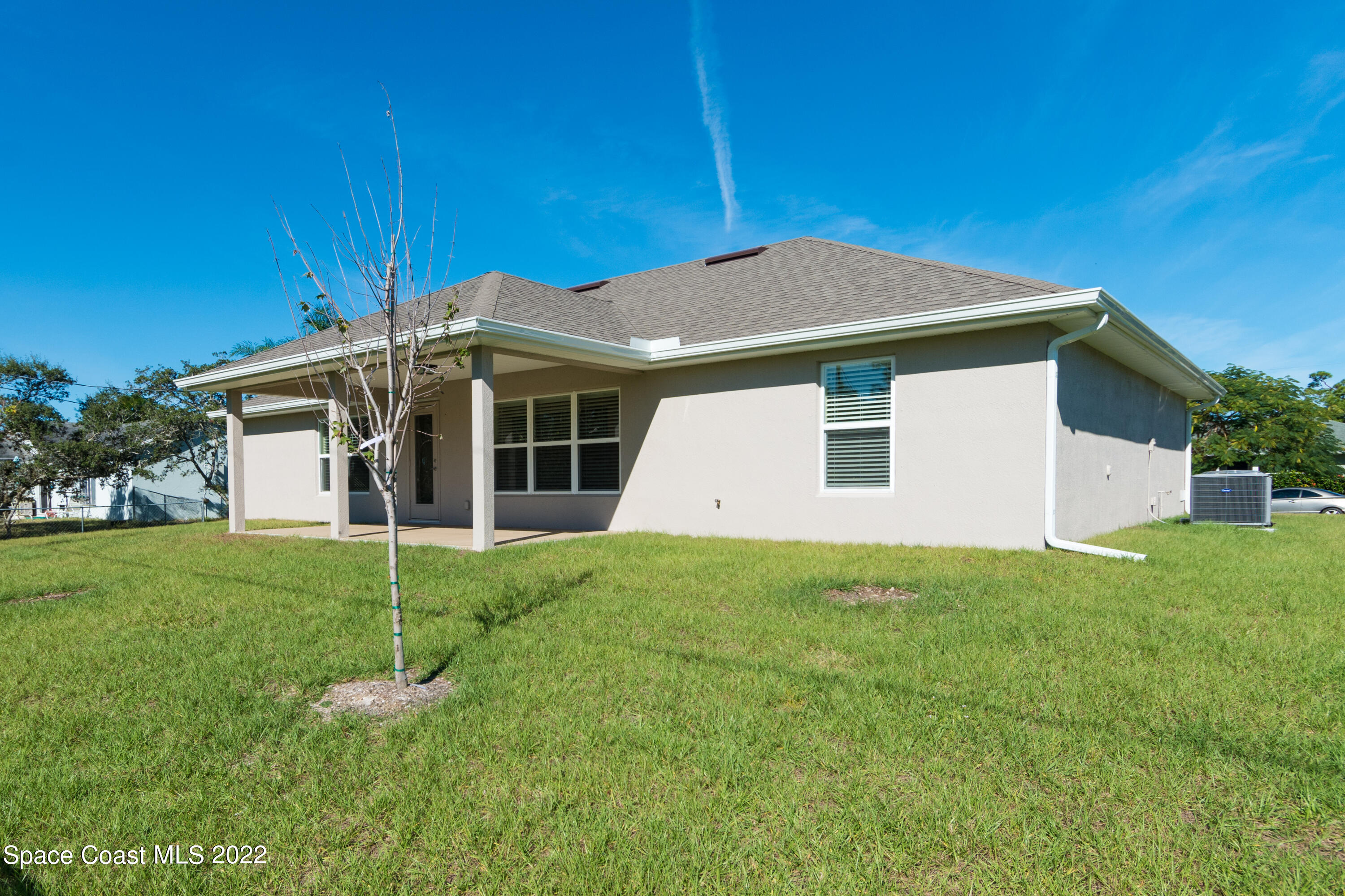 1490 Saxony Road Southwest Palm Bay, FL 32908 - Photo 15 of 15 a view of a house with a yard