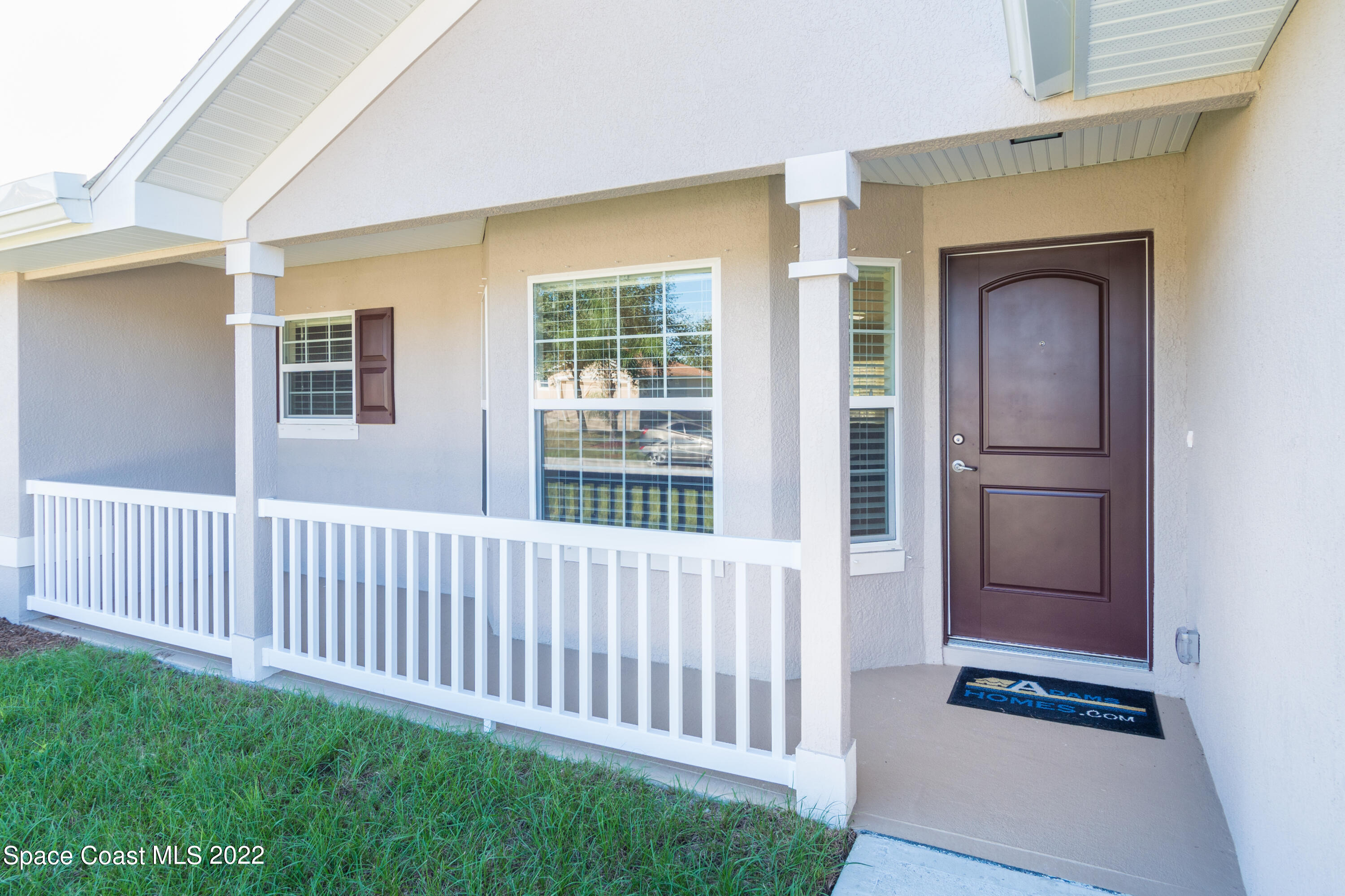 1490 Saxony Road Southwest Palm Bay, FL 32908 - Photo 2 of 15 a view of a porch with wooden floor and a fireplace