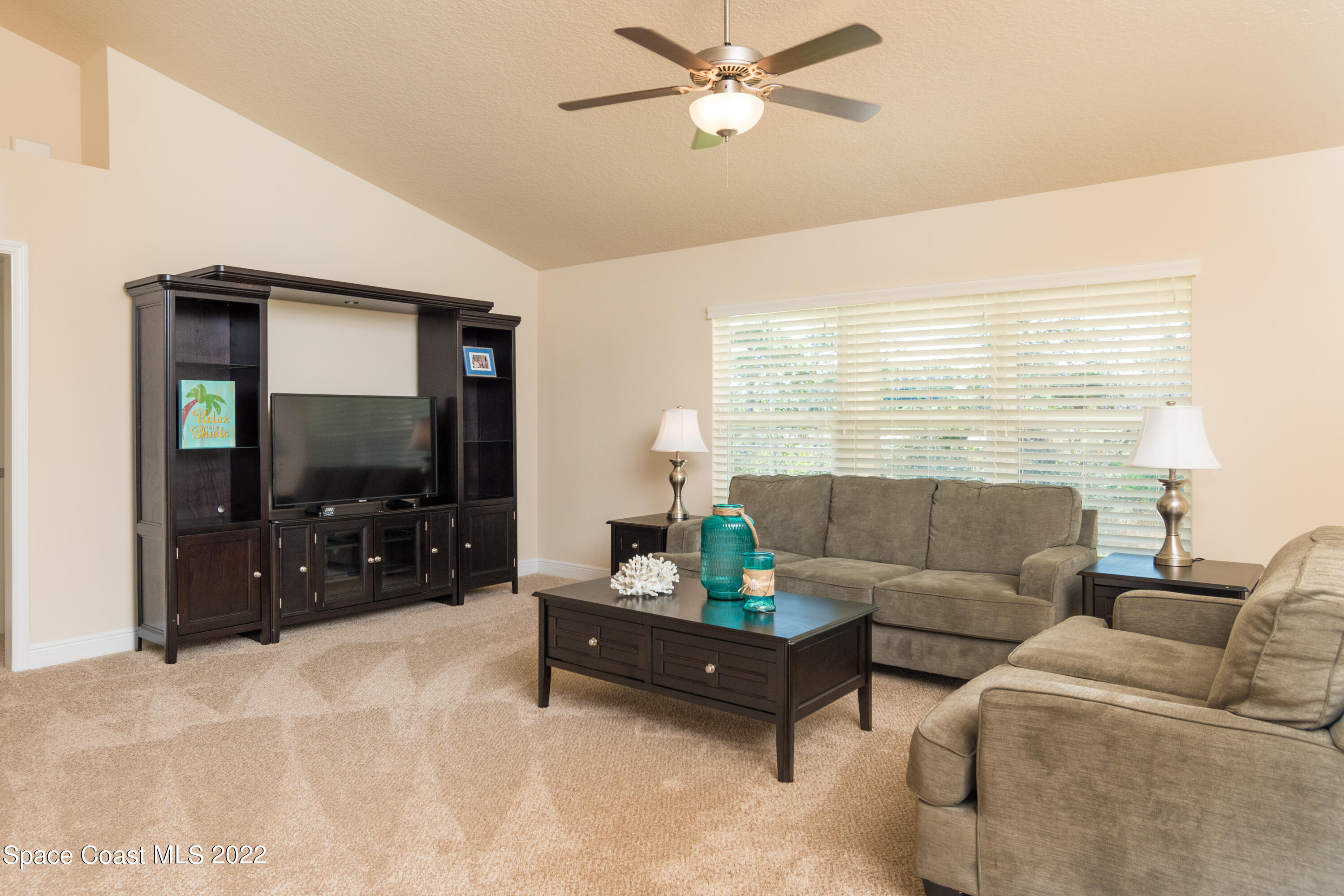 1490 Saxony Road Southwest Palm Bay, FL 32908 - Photo 9 of 15 a living room with furniture and a flat screen tv