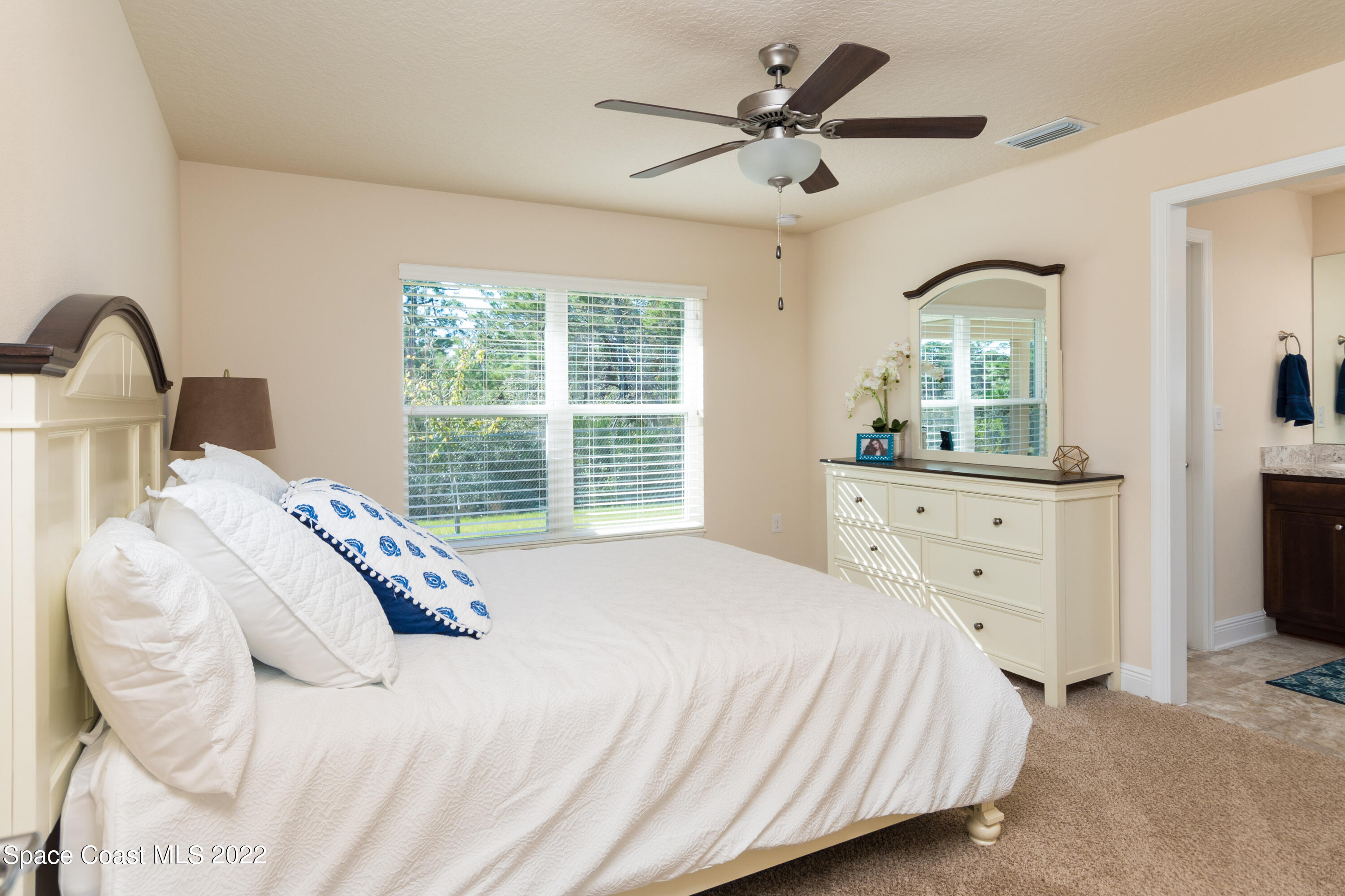1490 Saxony Road Southwest Palm Bay, FL 32908 - Photo 10 of 15 a bedroom with a large bed and a dresser