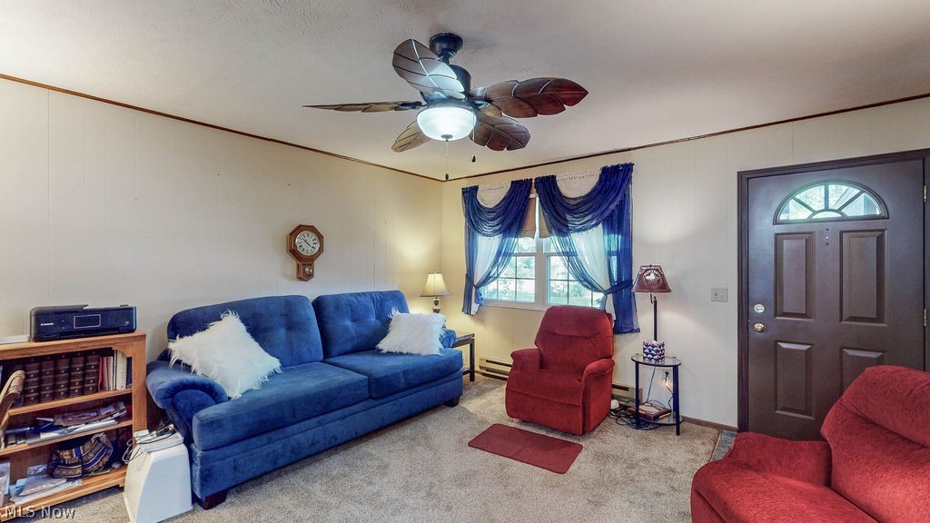 38667 Chestnut Ridge Road Elyria, OH 44035 - Photo 8 of 35 Bright interior featuring a ceiling fan with integrated lighting, a window with natural light, and a paneled entry door with an arched window