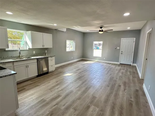 a kitchen with stainless steel appliances granite countertop a stove a sink and a microwave