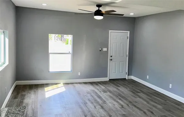 a view of a kitchen and a sink wooden floor and cabinets