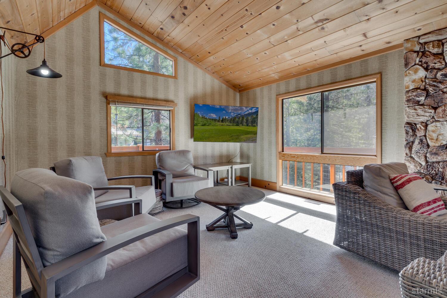 345 Granite Drive Stateline, NV 89449 - Photo 5 of 24 a living room with furniture a flat screen tv and a floor to ceiling window