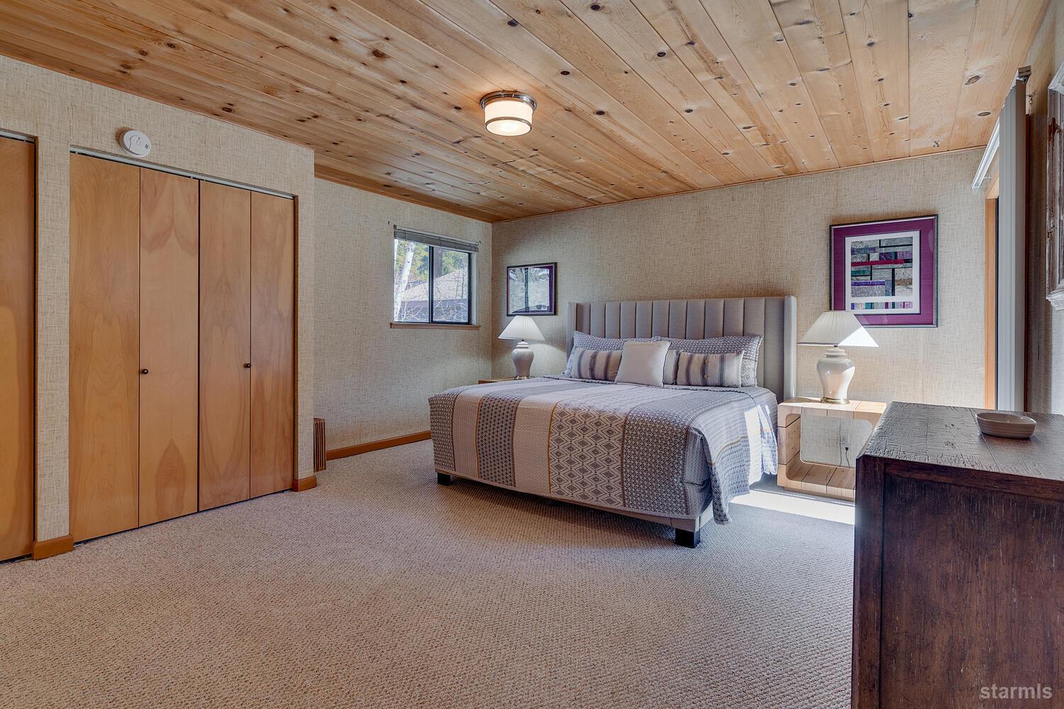 345 Granite Drive Stateline, NV 89449 - Photo 10 of 24 a spacious bedroom with a bed and a table