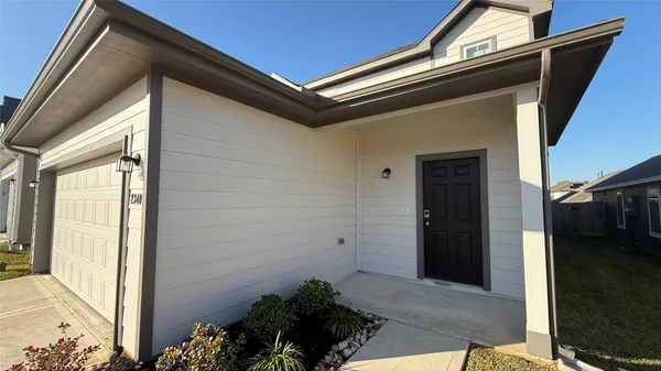 a large kitchen with granite countertop a refrigerator and a sink