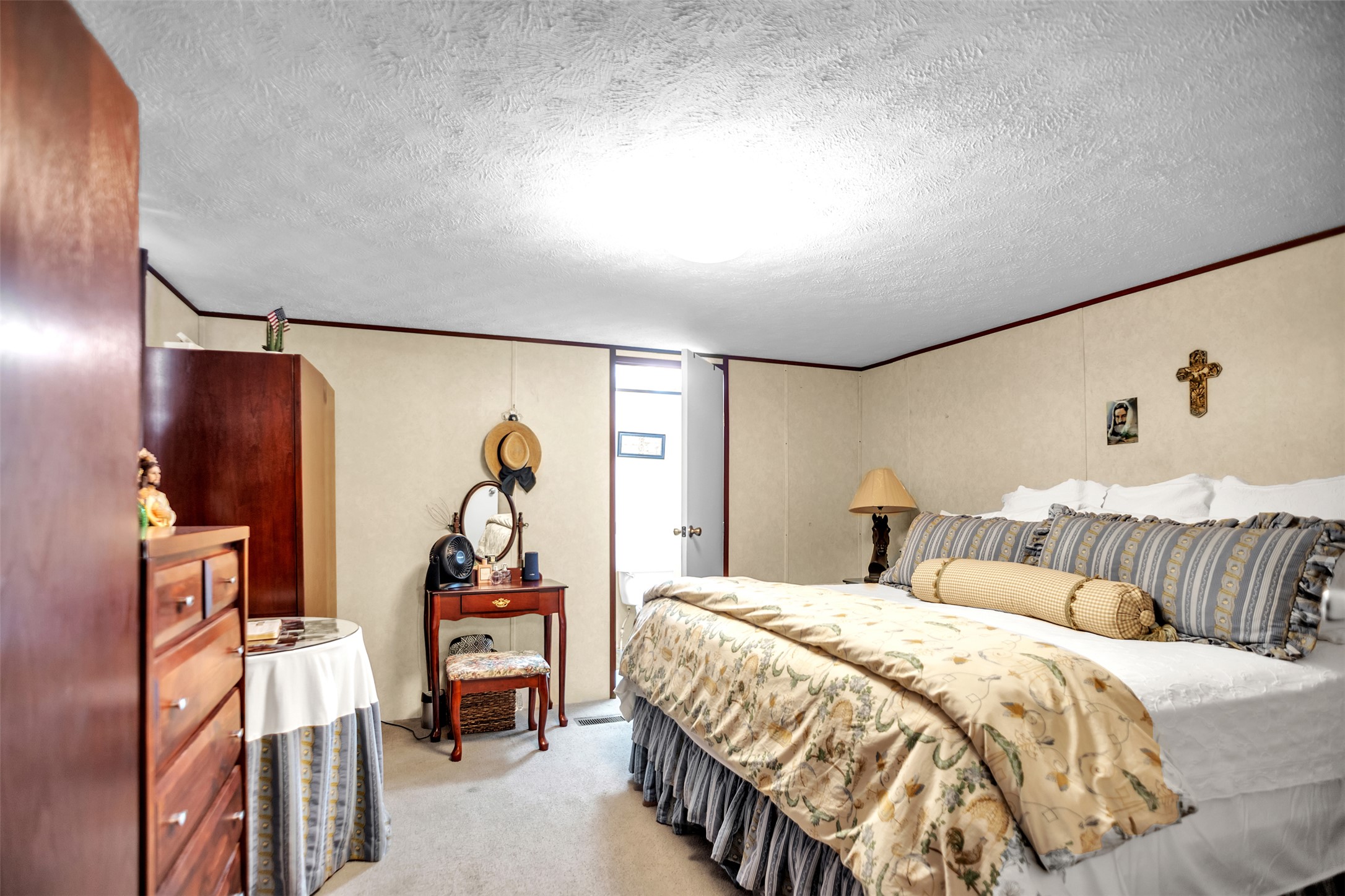 363 El Rey Drive Kyle, TX 78640 - Photo 18 of 40 Bedroom featuring light colored carpet and a textured ceiling