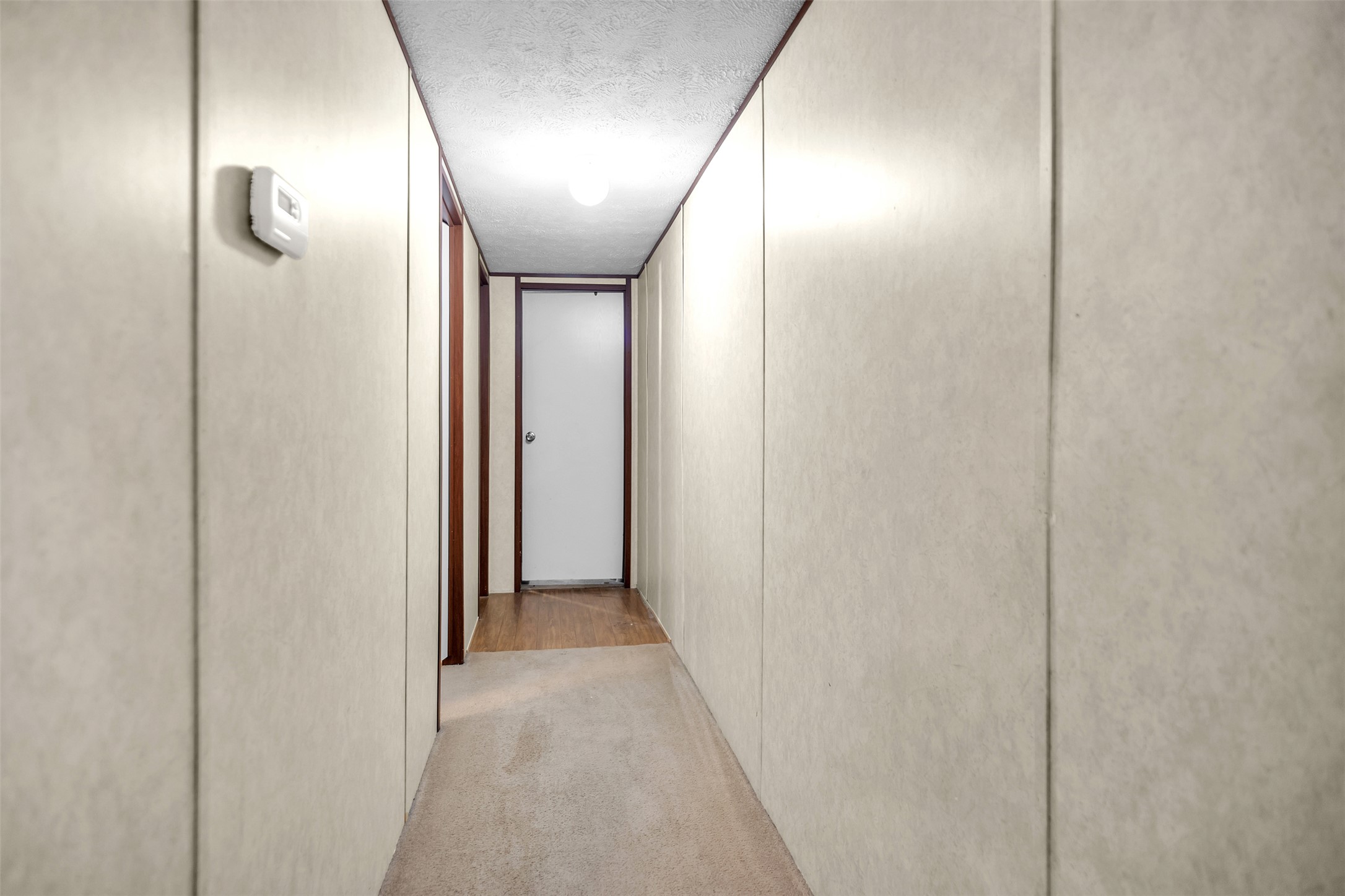 363 El Rey Drive Kyle, TX 78640 - Photo 20 of 40 Hallway featuring a textured ceiling and light carpet