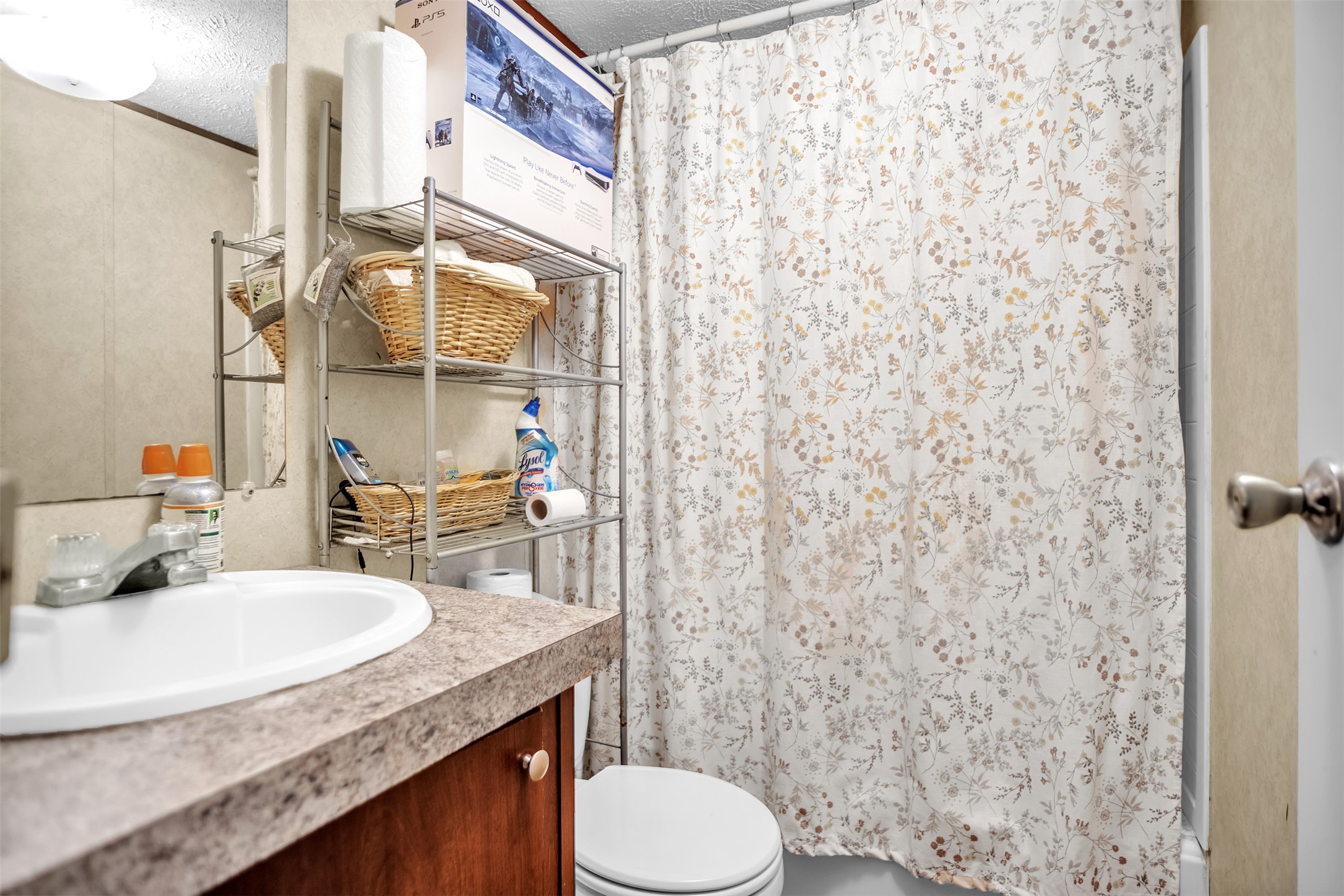 363 El Rey Drive Kyle, TX 78640 - Photo 23 of 40 Bathroom featuring vanity, a textured ceiling, and shower / bath combo with shower curtain