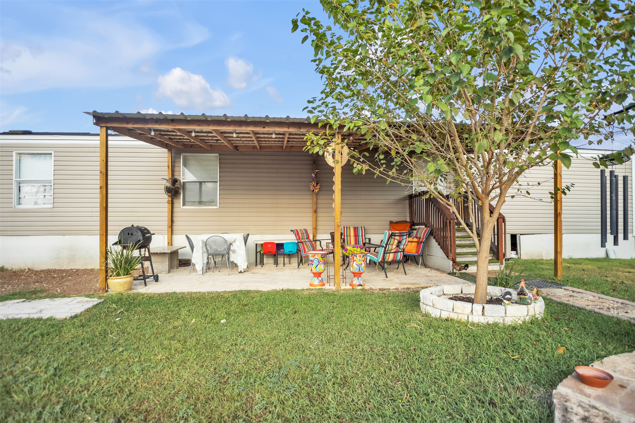 363 El Rey Drive Kyle, TX 78640 - Photo 27 of 40 Back of property with a yard and a patio area