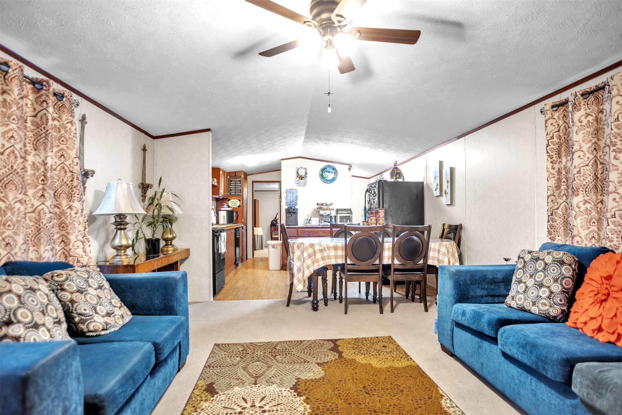 363 El Rey Drive Kyle, TX 78640 - Photo 6 of 40 Living room featuring carpet floors, ceiling fan, and crown molding