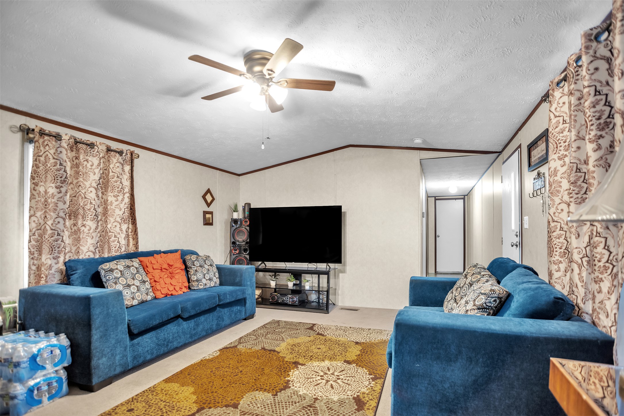 363 El Rey Drive Kyle, TX 78640 - Photo 8 of 40 Living area with carpet flooring, ornamental molding, and a ceiling fan