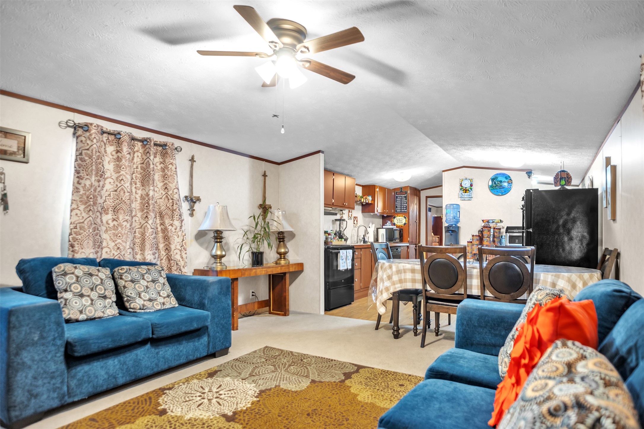 363 El Rey Drive Kyle, TX 78640 - Photo 9 of 40 Living area featuring light carpet and ceiling fan