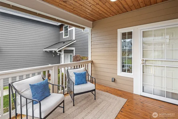a balcony with wooden floor and furniture