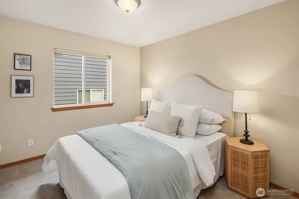 a bedroom with a bed and lamp
