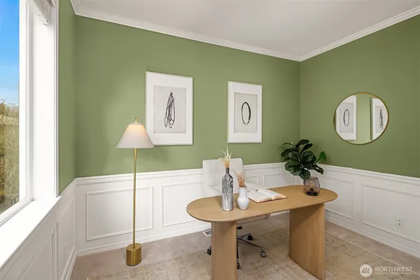 a view of a room that has a table and a chair in it