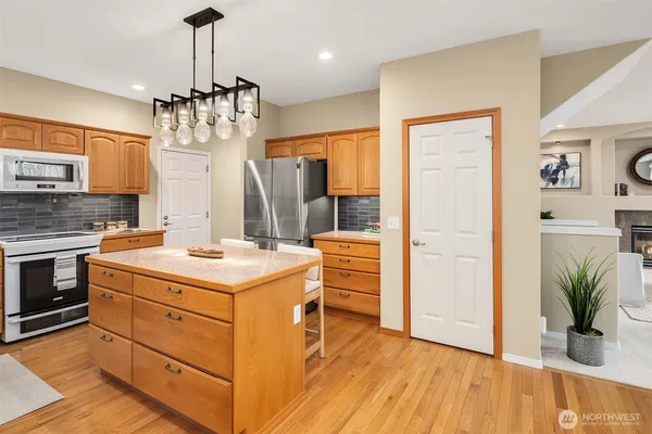a kitchen with a stove a refrigerator and a sink