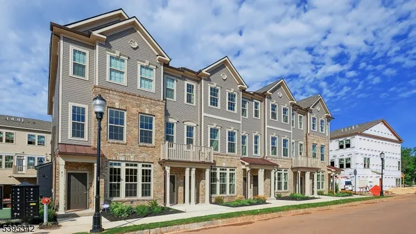 a front view of a residential apartment building with a yard