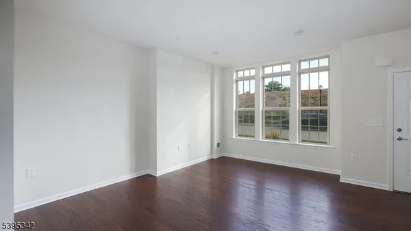 a view of wooden floor and windows in a room