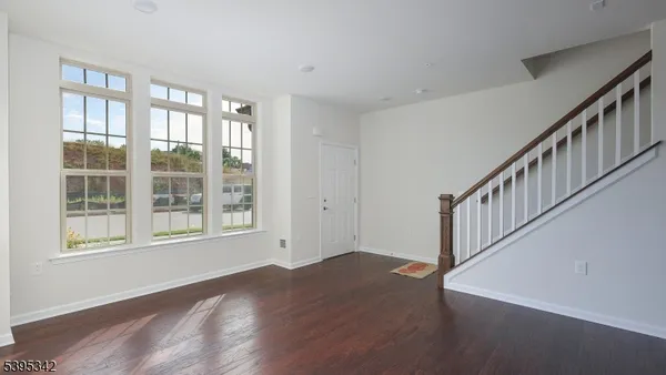 a view of an entryway with wooden floor