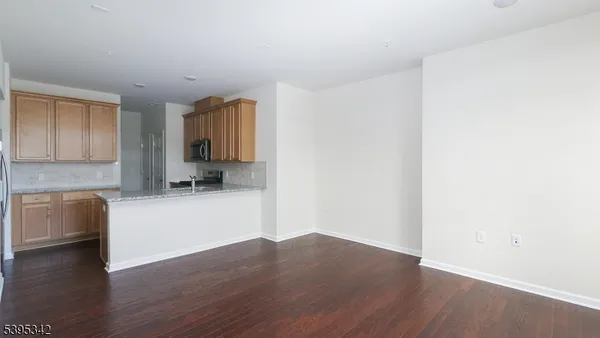 a room with wooden floor and furniture