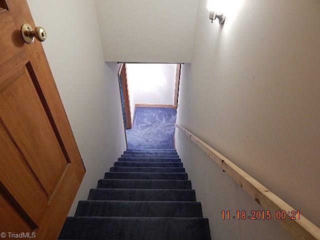 1077 Slate Road King, NC 27021 - Photo 25 of 30 Carpeted stairs leading to basement rooms.