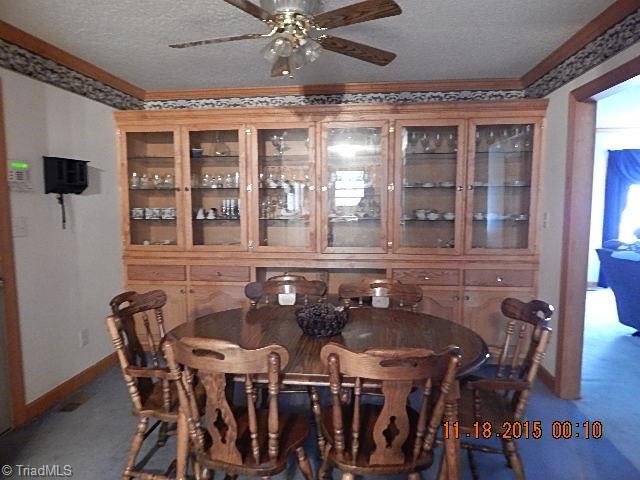 1077 Slate Road King, NC 27021 - Photo 4 of 30 Dining room has wall to wall china hutch.