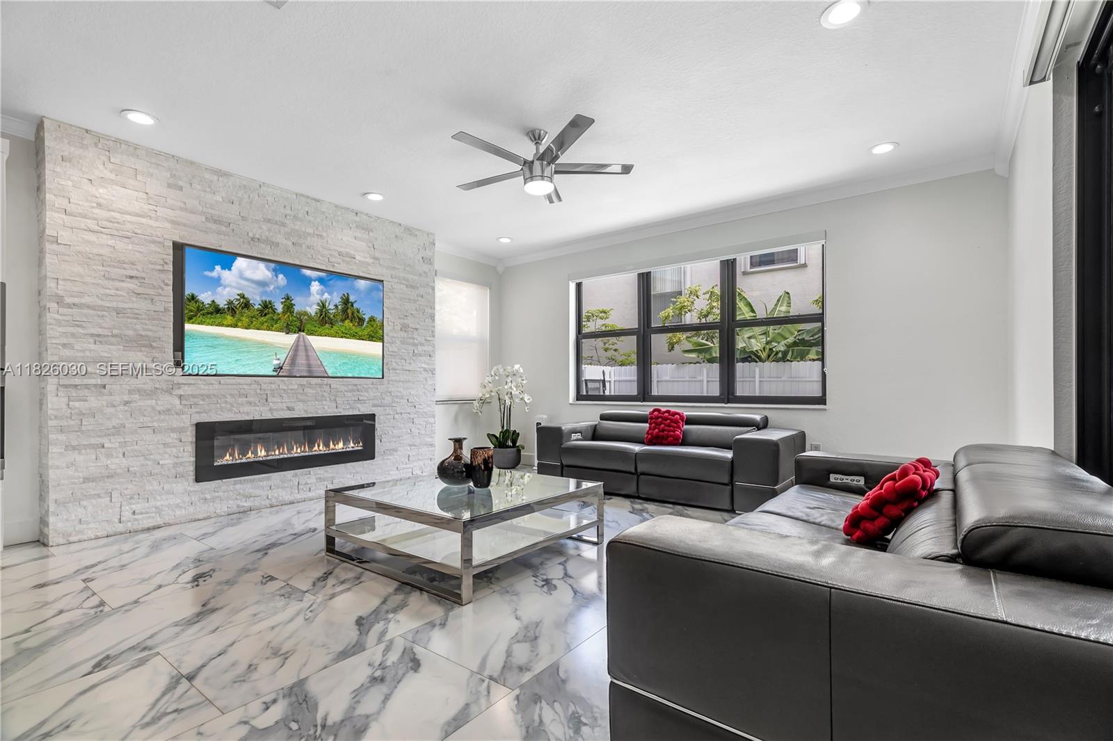 16488 Southwest 30th Street Miramar, FL 33027 - Photo 11 of 50 a living room with furniture and a flat screen tv