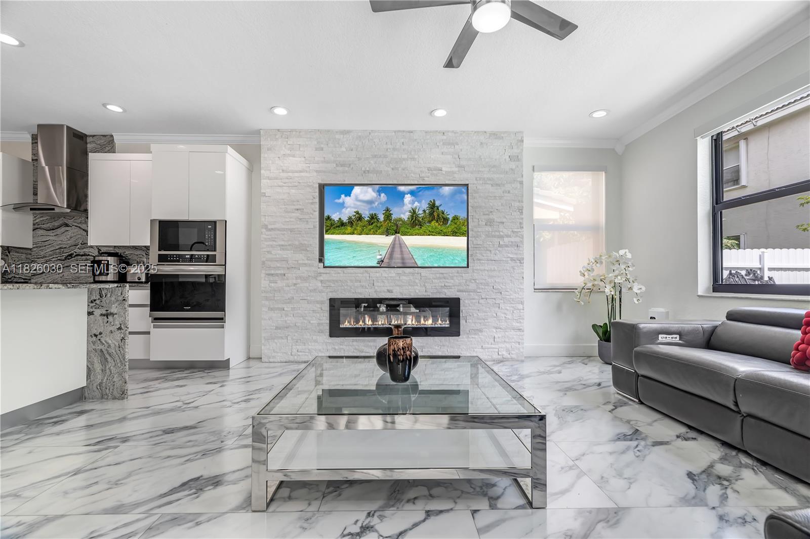 16488 Southwest 30th Street Miramar, FL 33027 - Photo 15 of 50 a living room with fireplace furniture and a flat screen tv