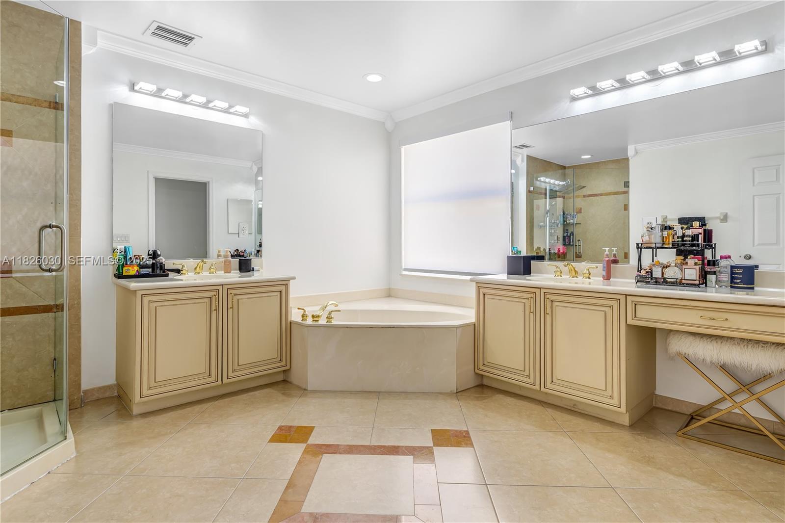 16488 Southwest 30th Street Miramar, FL 33027 - Photo 22 of 50 a bathroom with a sink a vanity a mirror and a bathtub
