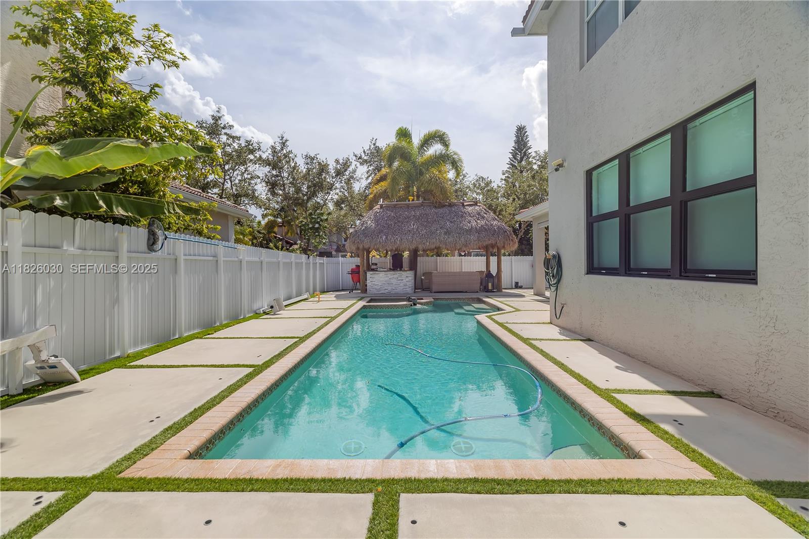 16488 Southwest 30th Street Miramar, FL 33027 - Photo 36 of 50 a view of a backyard with a small swimming pool