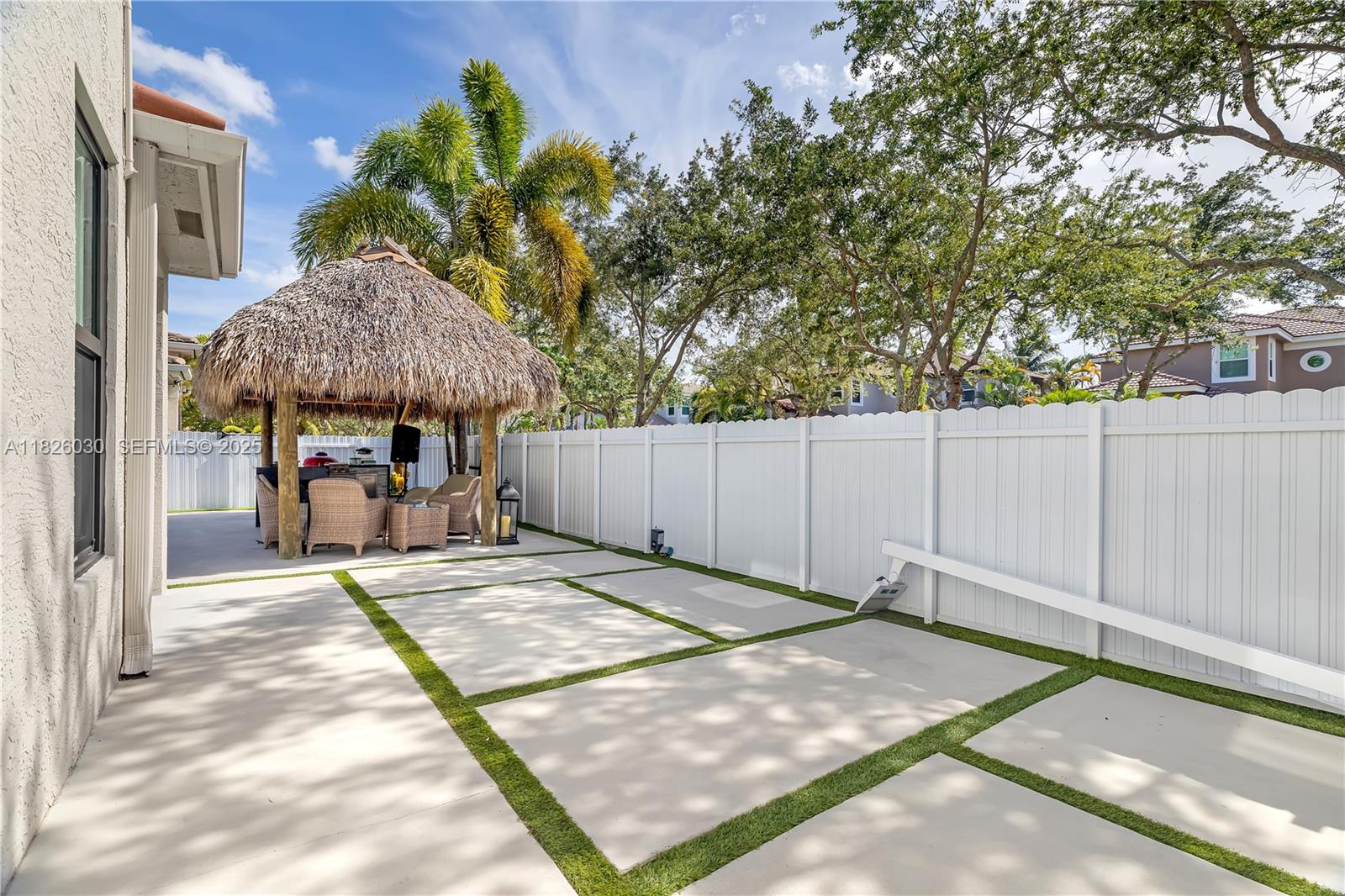 16488 Southwest 30th Street Miramar, FL 33027 - Photo 43 of 50 a view of a backyard with a small cabin and a chair