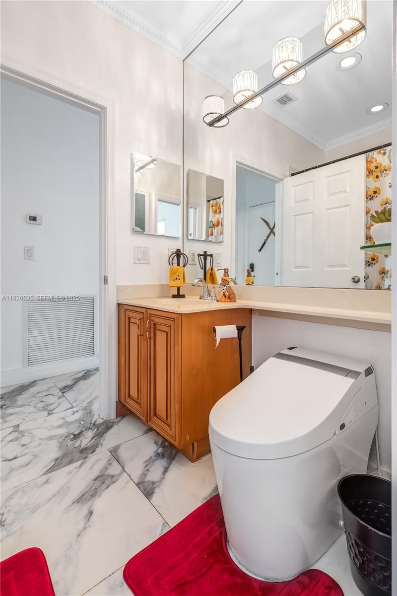 16488 Southwest 30th Street Miramar, FL 33027 - Photo 7 of 50 a bathroom with a toilet sink and mirror