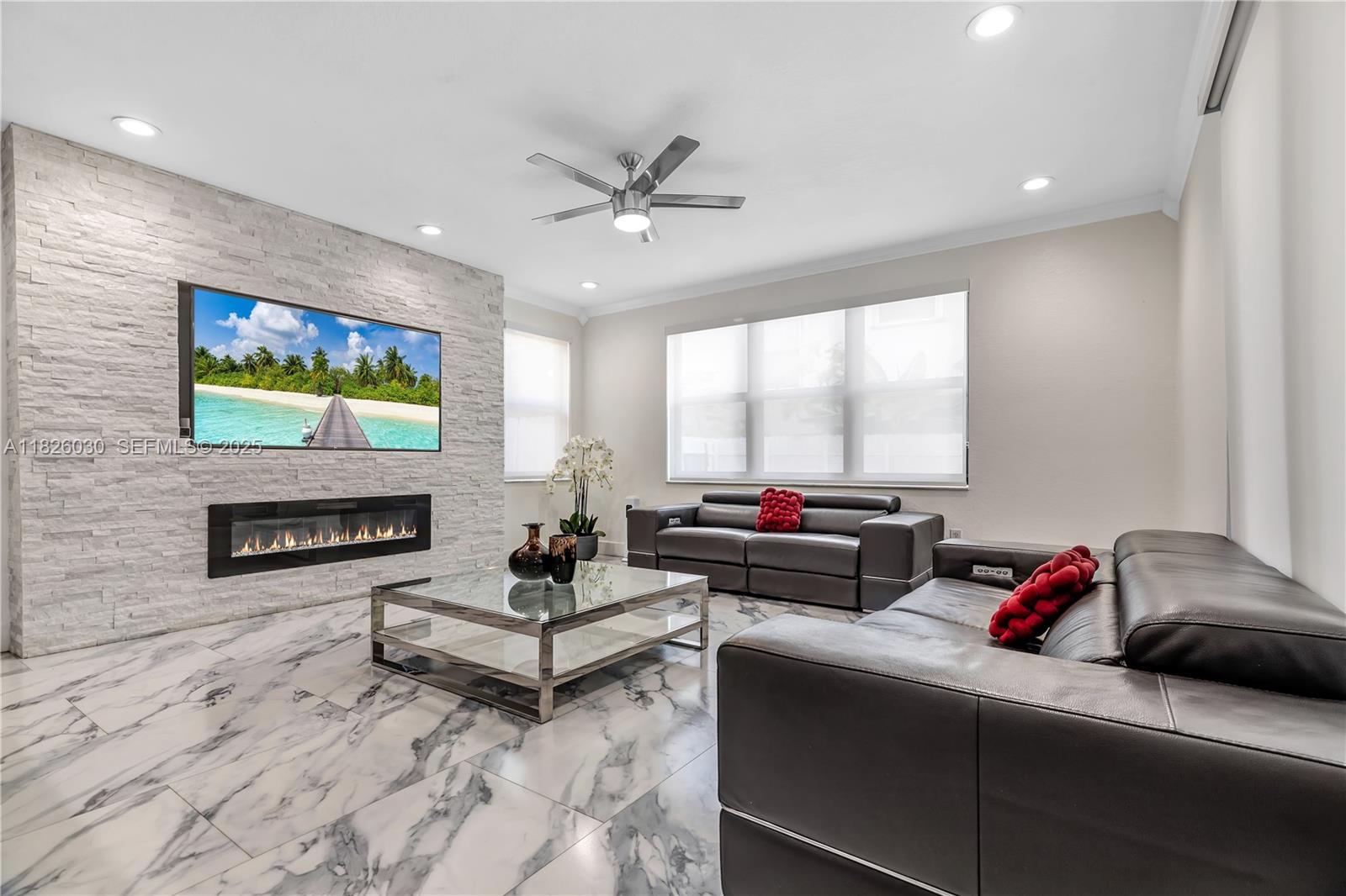 16488 Southwest 30th Street Miramar, FL 33027 - Photo 8 of 50 a living room with furniture a rug and a flat screen tv