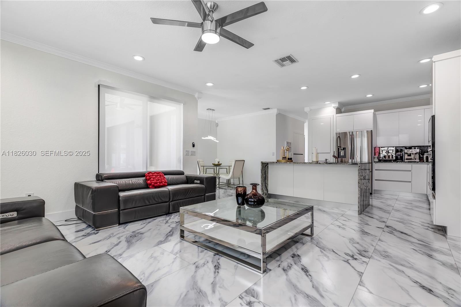 16488 Southwest 30th Street Miramar, FL 33027 - Photo 9 of 50 a living room with furniture and a view of kitchen